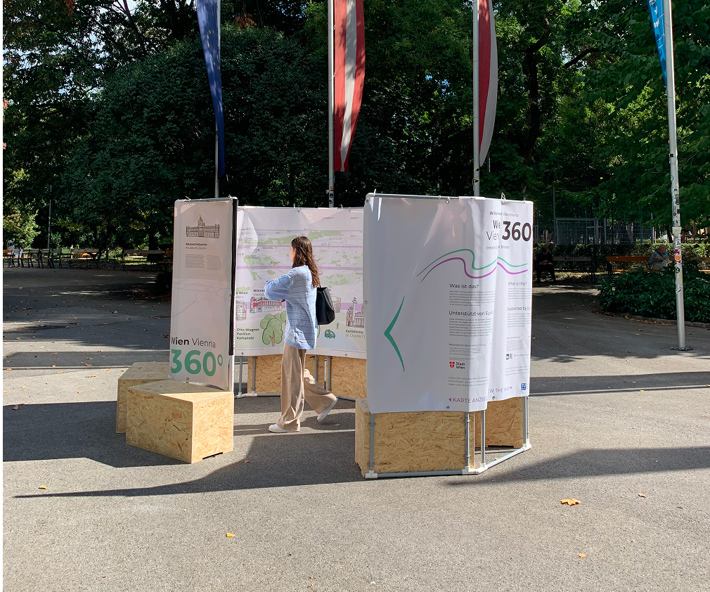 A person walking through a large tube coming out of the ground displaying a map inside